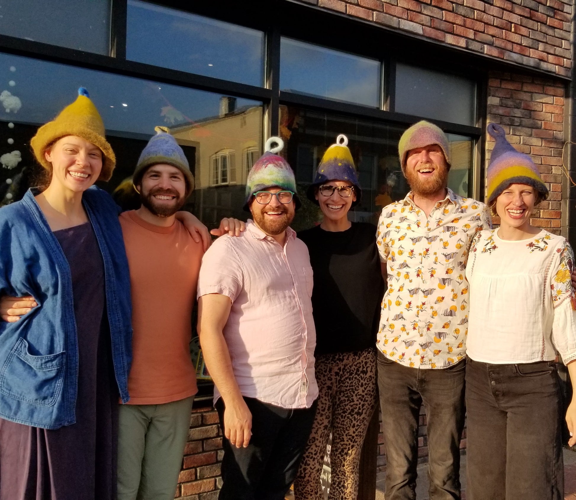 six students wearing their completed felt hats