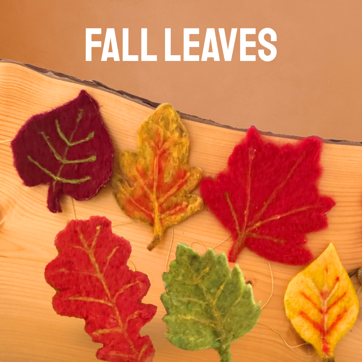 Needle felted fall leaves on a wood slab